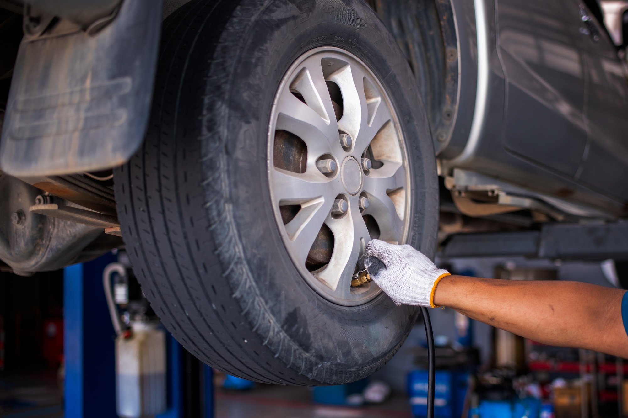 Mechanic car service checking air pressure nitrogen and inflating car tires is car care service and